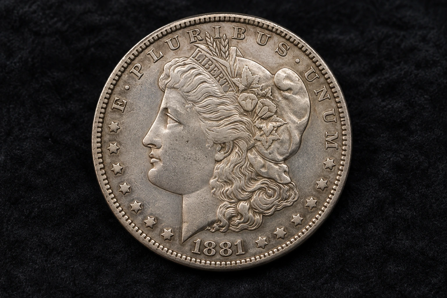 Sample 1881 Morgan silver dollar on its original dark velvet background